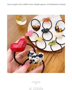 Detail view of heart-shaped acetate hair tie with dimensions 4.2x2.9cm and marble pattern