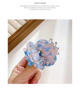Detail of blue and pink marbled acetate hair clip with high-quality metal spring