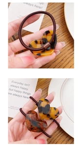 Detailed close-up of heart-shaped tortoiseshell hair ties with France Handmade text