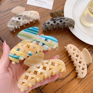 Checkered acetate hair claw clips in marble patterns for elegant hair styling