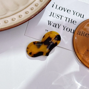 Detail of tortoise shell acetate barrette featuring gold Barrette La France lettering