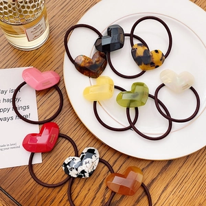 Set of colorful heart-shaped acetate hair ties with geometric faceted resin charms