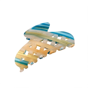 Checkered acetate hair claw clip with blue and yellow abstract marbled patterns