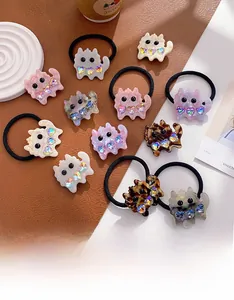Detail view of acetate cat hair clips and ties with heart crystals on a cozy background