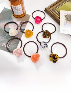 Set of 8 elegant floral hair ties with acetate flower charms in various trendy colors
