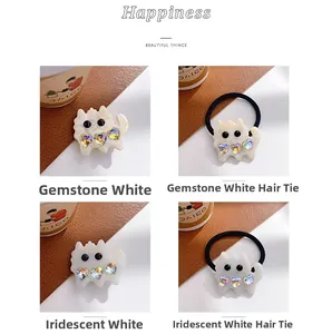 Detailed close-up of cute white acetate cat hair clips and ties with heart crystals