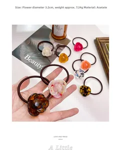 Detailed close-up of a 3.2cm acetate flower hair tie showing premium texture and pattern