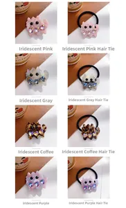 Close-up of iridescent acetate cat hair clips and ties with heart crystals in four colors
