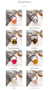Close-up of eight floral acetate hair scrunchies in various patterns and colors