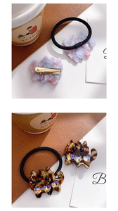 Detail of cat-shaped acetate hair clip and hair tie set with colorful heart rhinestones