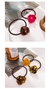 Detailed view of acetic acid flower hair rings in various colors with high elastic bands
