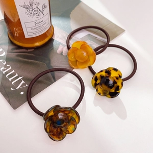 Three-piece set of elegant floral acetate hair ties in yellow and tortoiseshell patterns