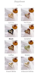 Detailed grid view showing eight colorful heart shaped hair claw clips with gold metal teeth
