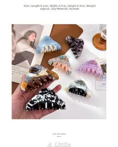 Detailed view of large acetate claw clip dimensions showing various marble textures