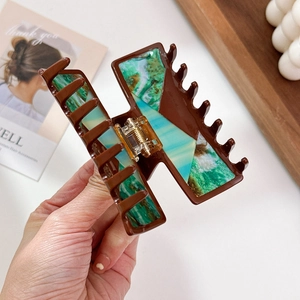 Large tortoiseshell and turquoise acetate hair claw clip with golden metal spring