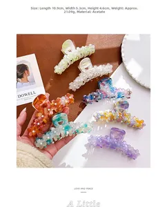 Detail shot of large acetate flower hair claw clips with dimensions and color variations