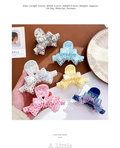Detailed macro view of acetate claw clips with hollow lace edges and bow designs