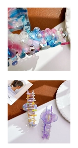 Detail of flower hair claw clip with colorful marble pattern and white pearl accents