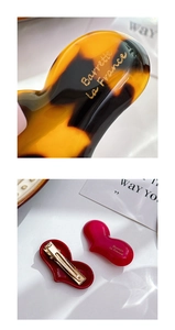 Close-up of heart-shaped acetate hair clips featuring elegant gold Barrette La France lettering