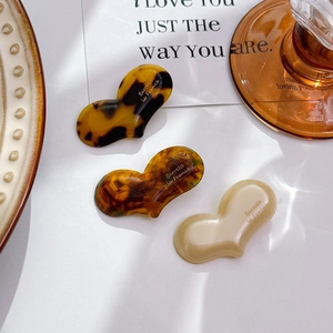 Three-piece acetate heart-shaped hair clips in tortoiseshell and cream finishes
