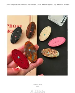 Detail showing colorful acetate heart hair clip with Love engraving and crystal