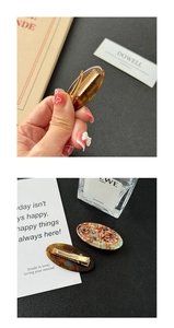 Detail view of tortoiseshell acetate hair clip with golden metal spring clip and glitter
