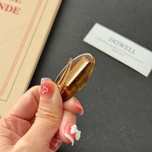 Elegant tortoiseshell patterned hair clip with colorful rhinestones and gold metal base