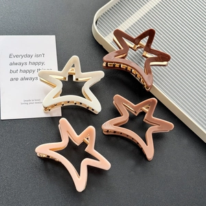 Star-shaped acetate claw clips in four Morandi colors with gold metal structures