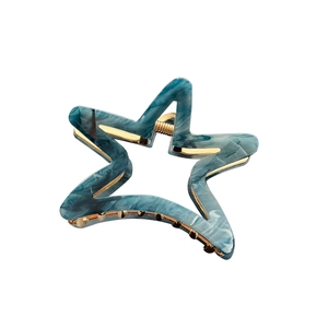 Star-shaped acetate hair claw clip with blue marble pattern and gold metal spring