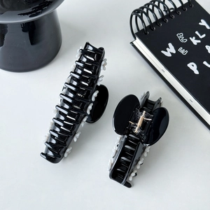 Elegant black acetate hair claw clips with white floral accents in two sizes
