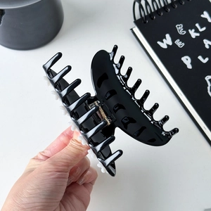 French style flower claw clip in black acetate with rhinestones and golden metal spring