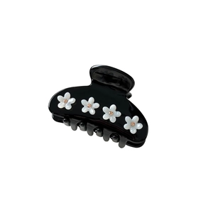 Elegant black acetate shark hair claw clip with white flower motifs and amber beads