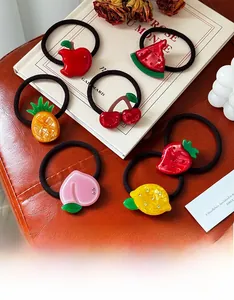 Detailed set of colorful fruit hair ties including apple and strawberry with elastic bands
