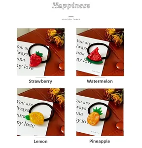 Detail of high-elasticity fruit hair ties with sparkling rhinestones and fruit charms