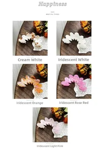 Detailed collection of wavy acetate hair claws in five iridescent colors on a retro table