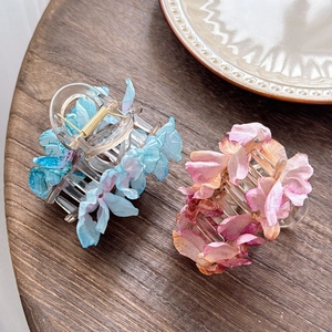 Elegant floral camellia hair claw clips in blue and pink silk petal gradient style