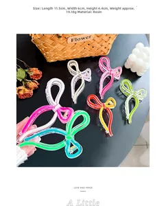 Detailed size view of large resin bow hair claw clips in various vibrant colors