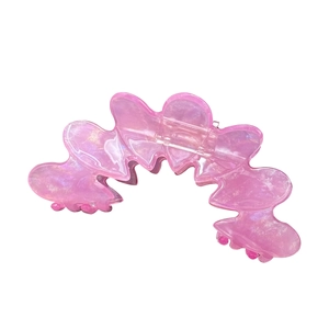 Pink pearlescent heart-shaped acetate hair claw clip with a shimmering translucent finish