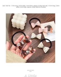 Detailed view of acetate bow hair accessories set with marble texture and rhinestones