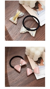 Detail of vintage bow hair ties and metal clips with marble patterns and rhinestones