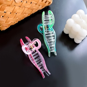 Vibrant pink and green large bow hair claws for women, elegant acrylic shark clips for long hair
