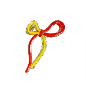 Elegant clear acrylic bow hair claw clip with red and yellow stripes and gold spring