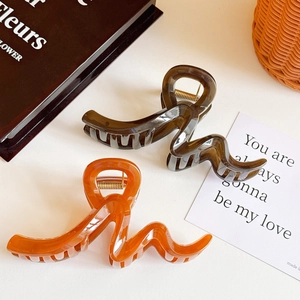 Large tortoiseshell and amber wave hair claws for women with thick hair, minimalist style