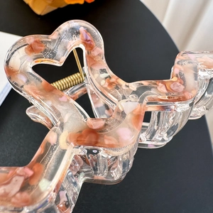 Large heart shaped resin hair claw clip with pink stone inserts and golden spring