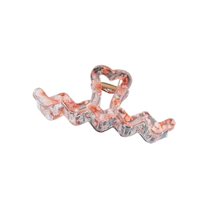 Extra large wavy resin hair claw clip with pink stone fragments and hollow heart handle