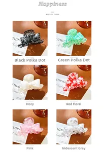Detailed close-up showing six colors of elegant acetate bow hair claws on leather base