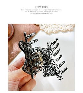 Detail shot of leopard print acetate hair claw with strong metal spring and teeth