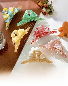 Flat lay of diverse acetate bow hair claws featuring marble patterns and candy colors