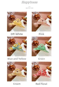 Detail view of acetate butterfly hair claws in six colors with elegant marble textures