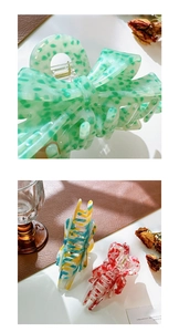 Detailed view of acetate butterfly hair claws in mint green, marble, and striped patterns